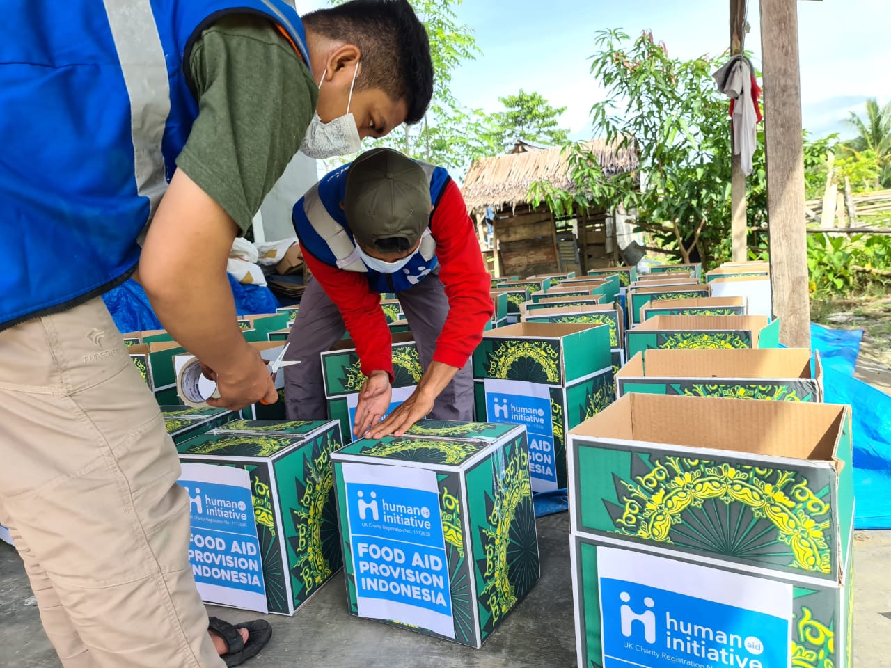 Volunteers packing boxes of food aid
